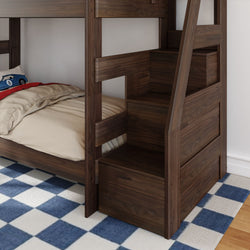 Dark walnut bunk bed with built-in staircase storage drawers, beige bedding, toy car pillow and blue checkered rug in a children's bedroom