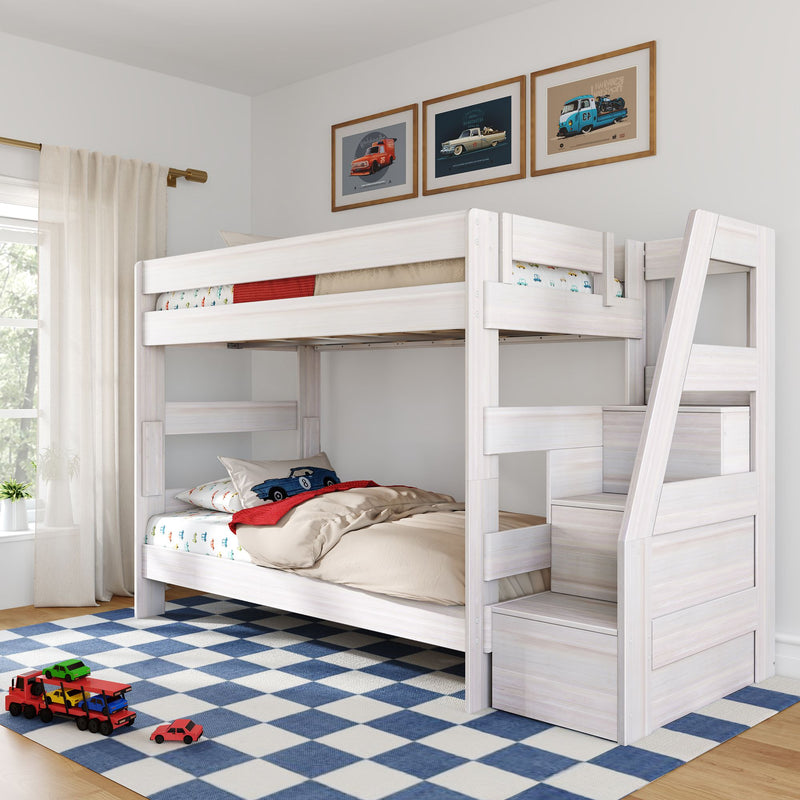 White wooden twin-over-twin bunk bed with built-in storage stairs in modern children's bedroom, blue-and-white checkered rug, toy cars on the floor and framed vintage car prints on the wall