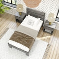 Top-down view of modern bedroom with gray wooden bed, neutral bedding, matching nightstands and lamps, woven pendant light, hardwood floors and patterned wallpaper