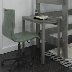 Simple home office setup with green swivel chair and wooden desk in a cozy room.