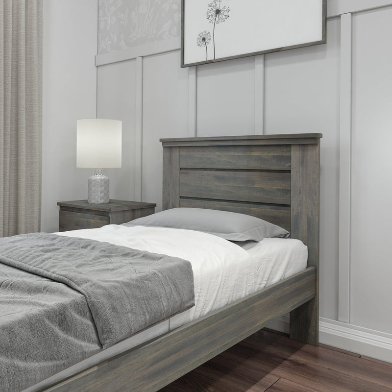 Rustic wooden bed frame in a modern bedroom with gray and white bedding, nightstand, and lamp.