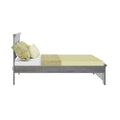 Side view of modern gray wooden platform bed with sage green sheets, textured throw and matching pillows for minimalist bedroom decor
