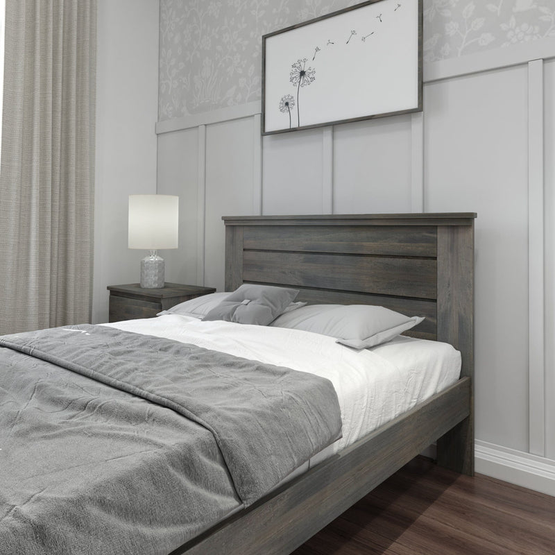 Neutral modern bedroom with gray wooden bed frame, white and gray bedding, bedside lamp on wood nightstand, framed dandelion wall art and board-and-batten paneling