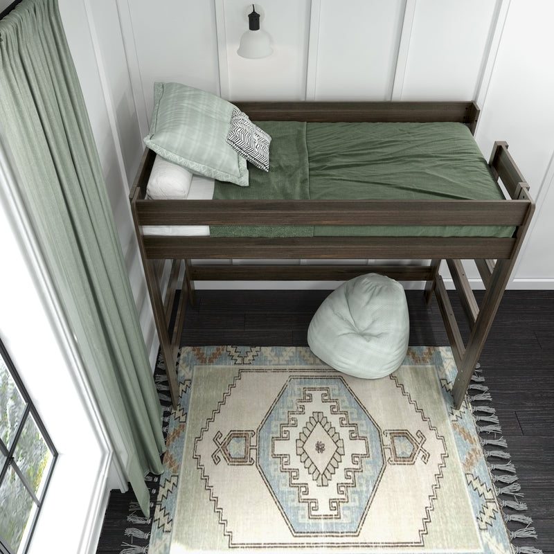Space-saving wooden twin loft bed with green bedding and decorative pillows over patterned boho rug, sage curtains, bean bag and pendant lamp in a modern kids' bedroom