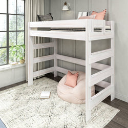Whitewashed wooden twin space-saving loft bed in a bright modern kids' bedroom with built-in ladder, pink pillows, bean bag chair, patterned area rug and large window