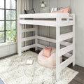 White twin loft bed with built-in ladder over cozy play area, pink bean bag and pillows, patterned rug and large window — space-saving kids bedroom
