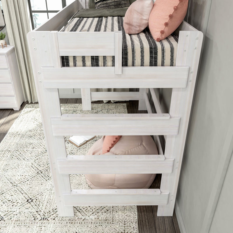 Whitewashed wooden loft bed with ladder and safety rails, black-and-white striped bedding and blush pink pillows over round pink bean bag in modern kids bedroom