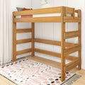 Solid oak twin loft bed with integrated ladder and guardrails over boho patterned rug in bright kids' bedroom