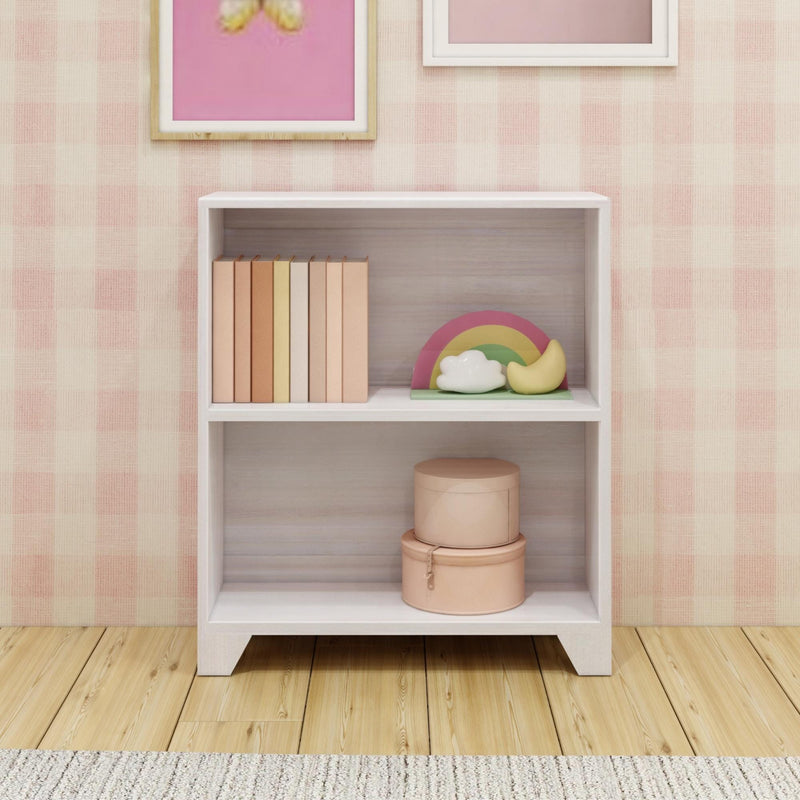 Simple white bookshelf with colorful books and decorative items, perfect for a kids' room.