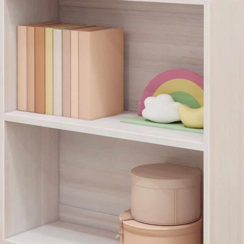 Aesthetic minimalist shelf decor with neutral books, pastel rainbow and cloud ornaments, and round storage boxes.