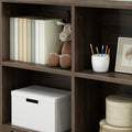 Cozy home office shelf with books, plush toy, and organized stationery in neutral tones.