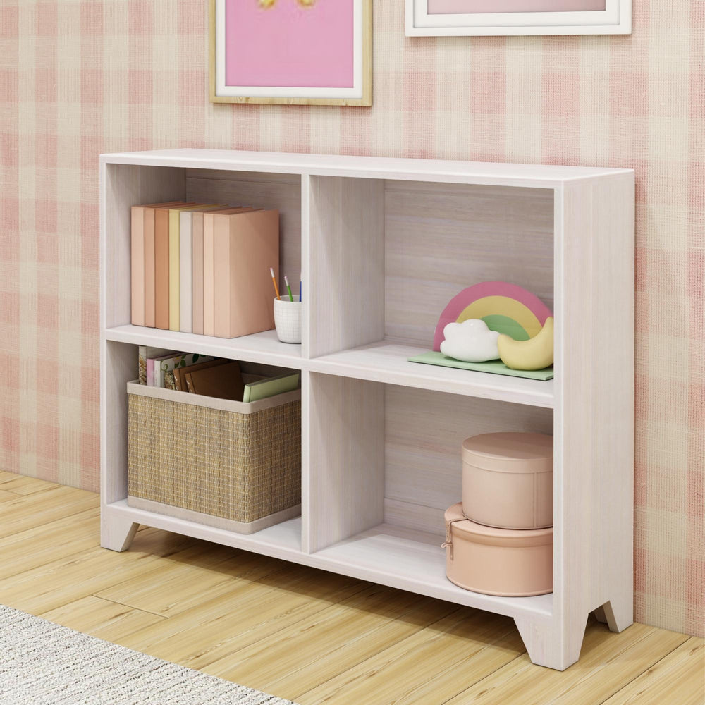 White wooden bookshelf with storage baskets, books, and decorative rainbow in a stylish pink room.