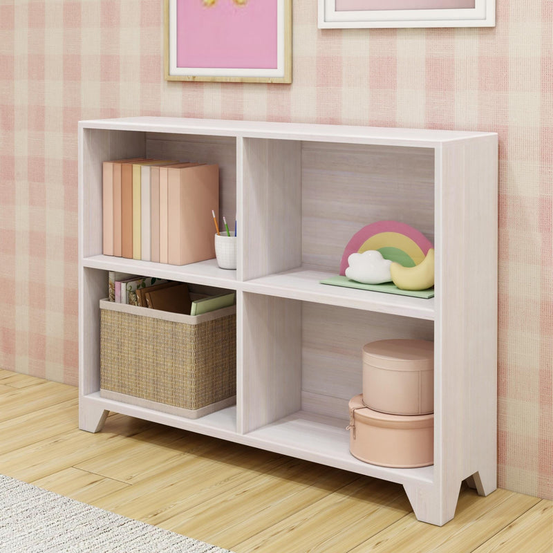 White wooden bookshelf with storage baskets, books, and decorative rainbow in a stylish pink room.