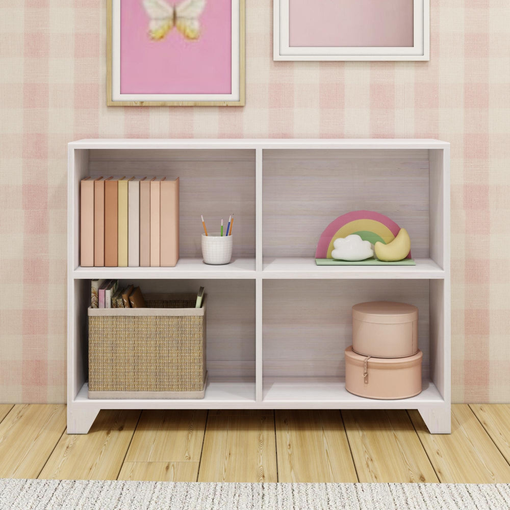 Modern children's bookshelf with decorative items and storage baskets in a pastel-themed room.