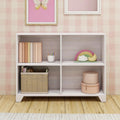 Modern children's bookshelf with decorative items and storage baskets in a pastel-themed room.