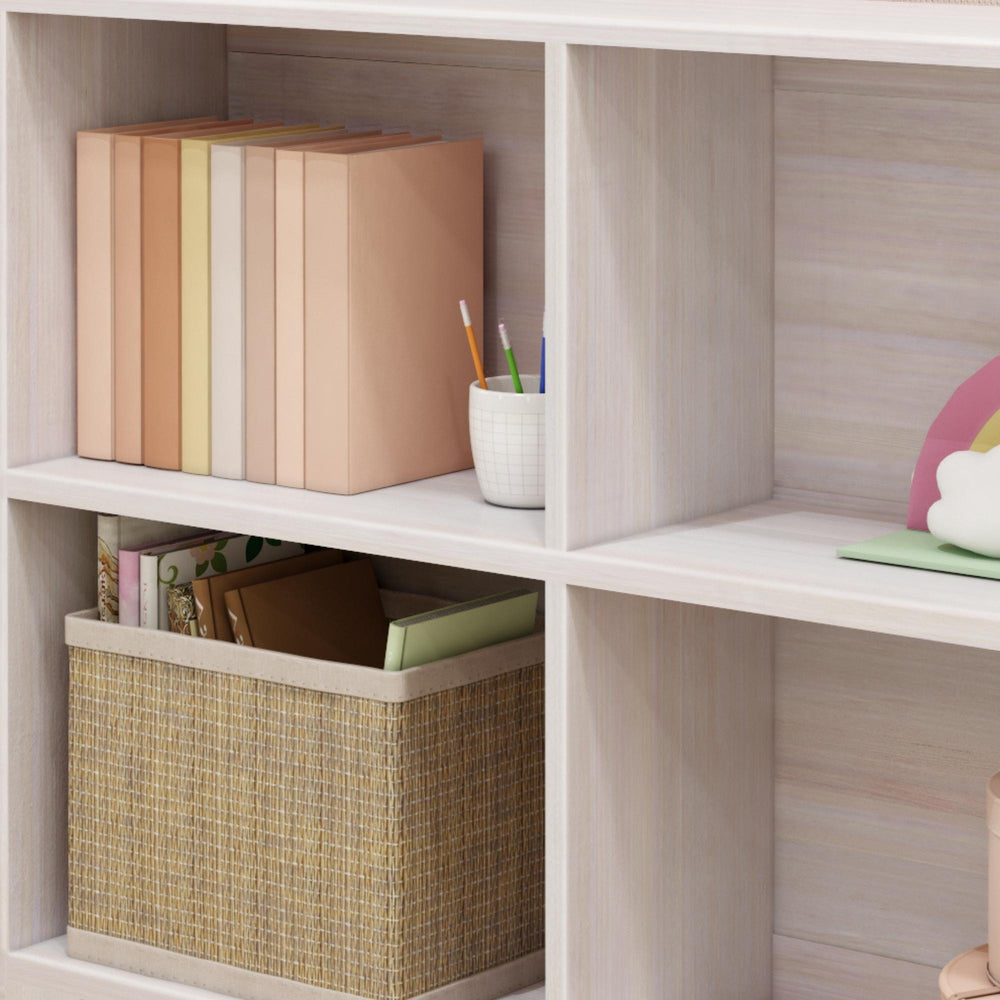 Bookshelf with colorful books, pencil holder, and storage basket for home office organization.