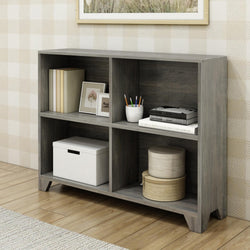 Gray wooden bookshelf with decorative items and books in a modern living room setting.