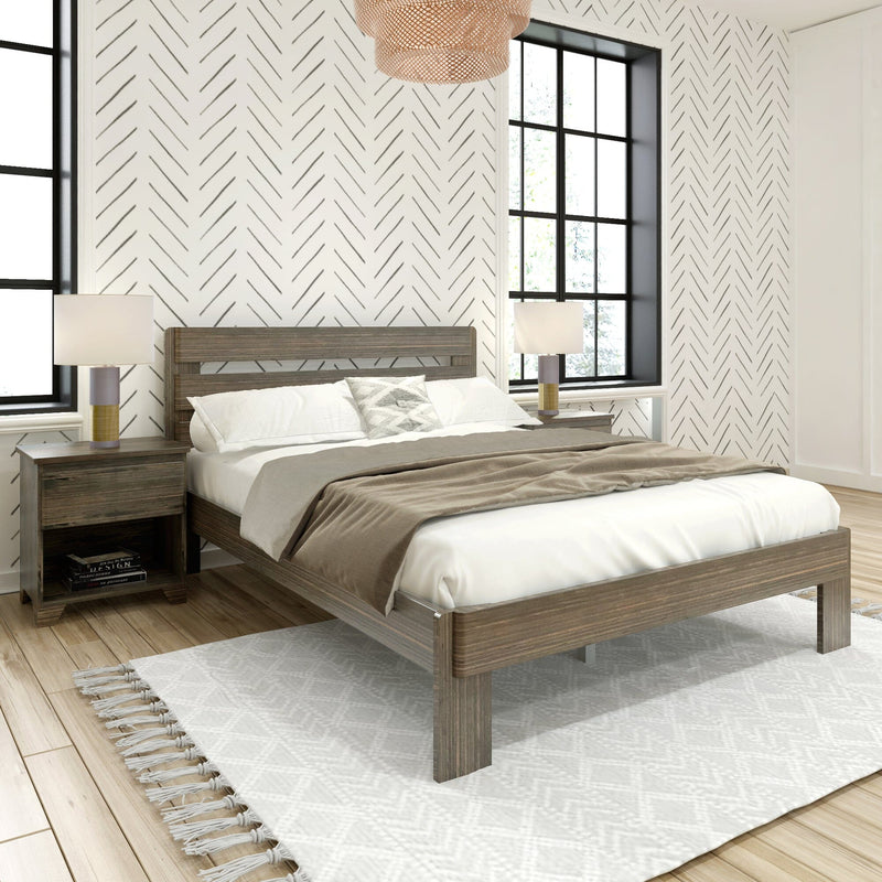 Minimalist modern bedroom interior with wooden platform bed, neutral bedding, patterned chevron wallpaper, black-framed windows, bedside lamps and textured area rug