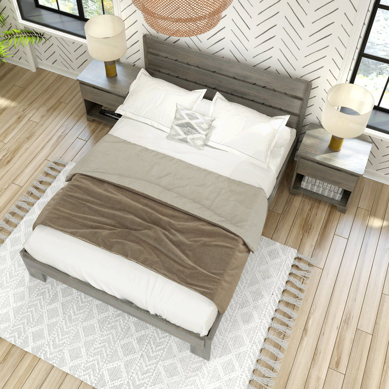Modern farmhouse bedroom top-down view of a wooden bed frame with neutral bedding, patterned accent wallpaper, bedside lamps and hardwood floors