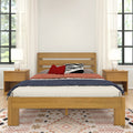 Modern bedroom with oak platform bed, matching nightstands and lamps, red and zebra accent pillows, sheer white curtains and patterned boho rug.