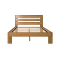 Solid wood slatted platform bed frame with horizontal plank headboard in natural oak finish, modern farmhouse style