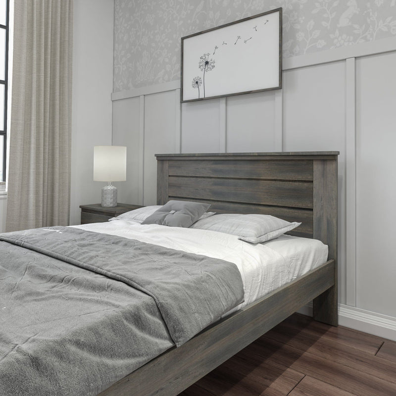 Modern farmhouse gray wooden bed frame with gray bedding, nightstand and lamp in a neutral bedroom featuring paneled wall, dandelion wall art, curtains and hardwood floor