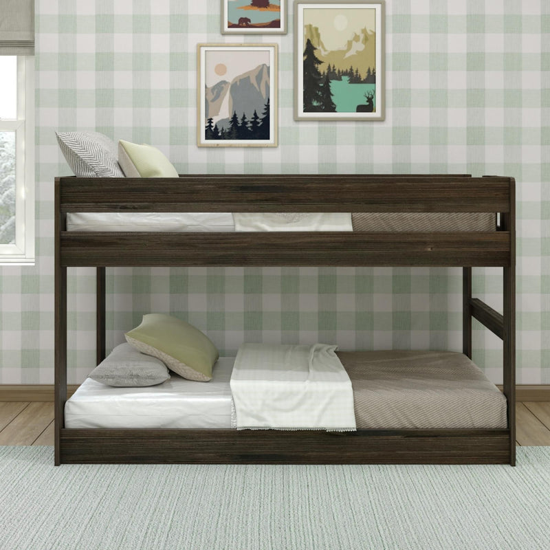 Dark wood bunk bed with green and gray bedding in a cozy bedroom with checkered wallpaper and nature-themed wall art.