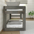 Gray twin-over-twin reclaimed wood bunk bed with neutral bedding in a farmhouse kids' bedroom with hardwood floor and potted plant