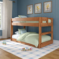 Kids wooden bunk bed with mint green bedding in coastal blue paneled bedroom, floral wall art, checkered rug and wooden toys