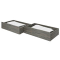 Gray wood under-bed trundle storage drawers (set of 2) with folded white bedding — low-profile bedroom storage for twin beds