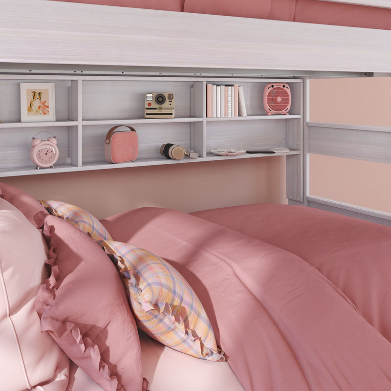 Cozy pink bedroom with pastel bedding and ruffled pillows, built-in shelf displaying alarm clock, retro camera, headphones and books