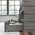 Wooden bunk bed with storage drawers and cozy bedding near large window in modern bedroom.