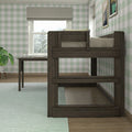 Dark wood loft bed over study desk in a bright kids' bedroom with green gingham wallpaper and window