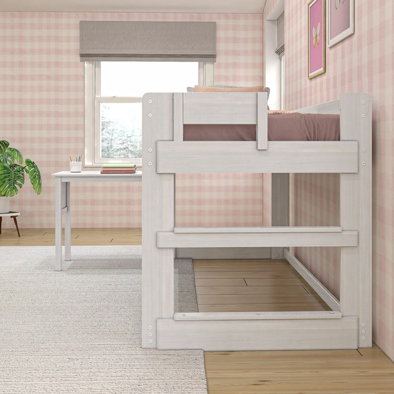 High loft bed in cozy bedroom with desk underneath, pink checkered wallpaper, and natural light.