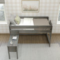 Top-down view of a rustic wooden loft twin bed with neutral bedding and decorative pillows, built-in desk with notebooks and pencil cup, plaid wallpaper and framed botanical art in a cozy farmhouse bedroom