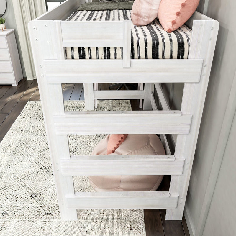 White wooden bunk bed with striped mattress and decorative pillows, situated on a patterned rug in a modern bedroom.