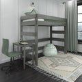 Gray wooden loft bed with built-in study desk, mint green pillow and bean bag, patterned rug and curtains in a modern kids' bedroom