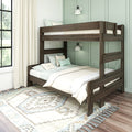 Dark wood bunk bed in a cozy kids' bedroom with mint green paneled wall, neutral bedding and pillows, patterned area rug and sunlit window