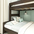 Dark walnut bunk bed with mint green bedding, textured cream curtains and white wall sconce in a modern bedroom