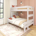 White wooden bunk bed in a boho kid’s bedroom with pink accent wall, neutral bedding, textured pillows, patterned area rug and sunlit window