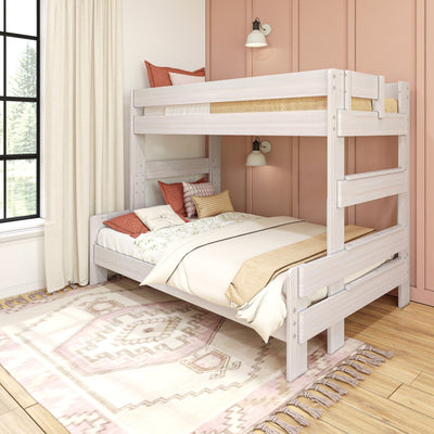 White wooden bunk bed in a boho kid’s bedroom with pink accent wall, neutral bedding, textured pillows, patterned area rug and sunlit window
