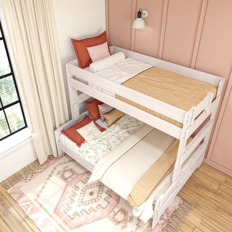 White wooden twin-over-full bunk bed in pink bedroom with cozy boho bedding, ladder, patterned rug and sunlit window