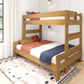 Wooden bunk bed in natural oak finish with orange and navy bedding, patterned area rug and wall sconce in a bright modern bedroom
