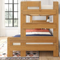 Natural oak wooden bunk bed with safety rails and ladder, cozy coral and navy bedding, wall sconce and large window in a bright modern kids bedroom