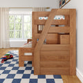Solid wood twin-over-twin bunk bed with built-in storage and diagonal ladder in bright kids' bedroom with blue checkered rug, toy cars and large window