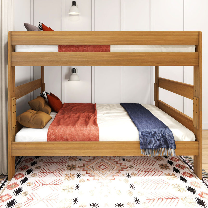 Solid wood bunk bed in cozy children's bedroom with white paneled wall, pendant lights, patterned boho rug and rust and navy throws