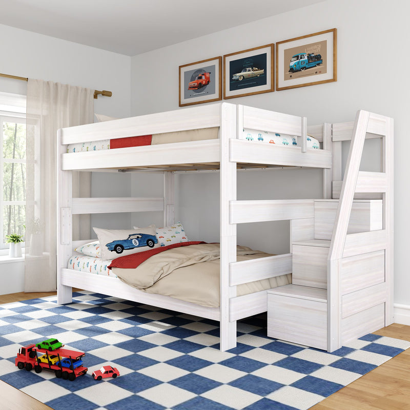 White wooden bunk bed with built-in staircase and storage in a bright kids' bedroom, car-themed bedding and toy cars on a blue checkered rug, framed vintage car prints and natural window light.