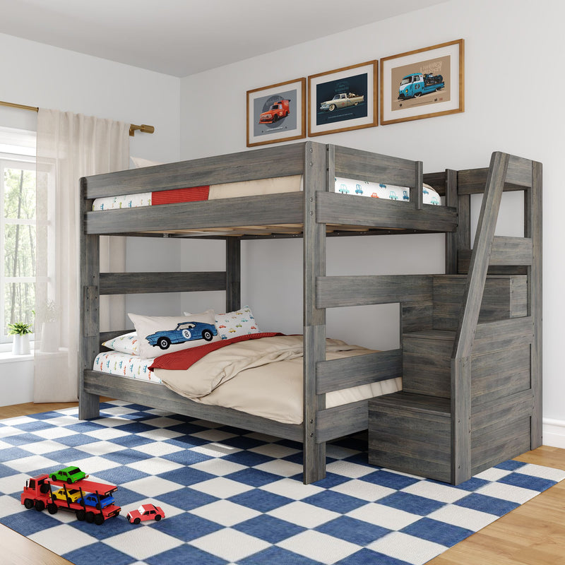Gray wooden twin-over-full bunk bed with built-in stair storage in a kids' bedroom, car-themed bedding, blue-and-white checkered rug and toy cars
