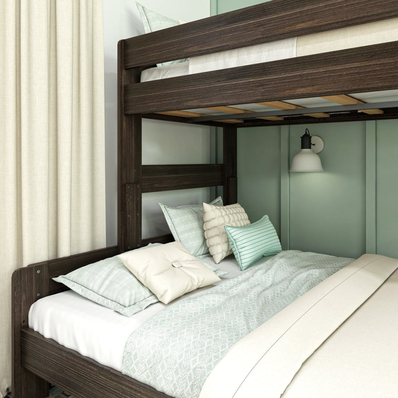 Dark wood bunk bed with mint-green bedding, textured throw pillows and white wall sconce in a cozy modern bedroom with beige curtains