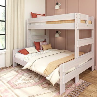Whitewashed wooden twin-over-full bunk bed in cozy kids bedroom with pink accent wall, neutral layered bedding, decorative pillows and linen curtains